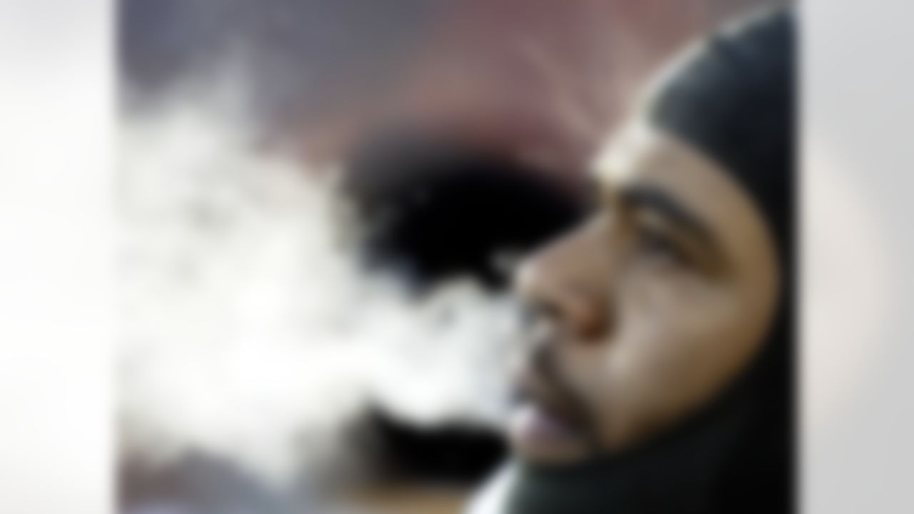 Steam rises off Green Bay Packers' Nick Luchey on the bench in the first quarter during a frigid game against the Jacksonville Jaguars, in Green Bay, Wis. on Dec. 19, 2004. (AP Photo/Morry Gash)