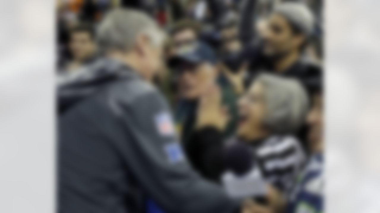 Teresa Dahlquist reacts after getting a hug from Seattle Seahawks head coach Pete Carroll during media day for the NFL Super Bowl XLVIII football game Tuesday, Jan. 28, 2014, in Newark, N.J. (AP Photo/Matt Slocum)