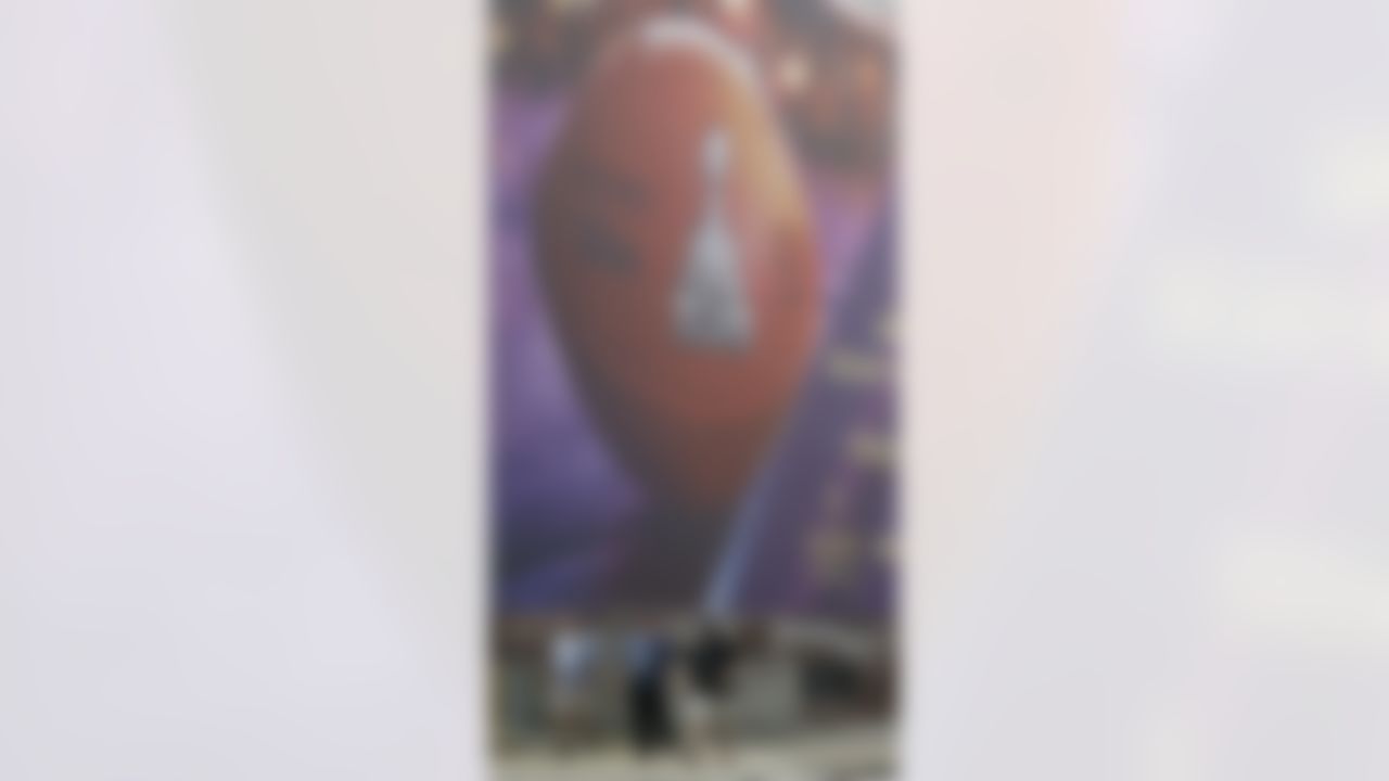Pedestrians walk past a large Super Bowl XLVII banner outside the Mercedes-Benz Superdome on Monday, Jan. 28, 2013, in New Orleans. The San Francisco 49ers are scheduled to face the Baltimore Ravens in the NFL Super Bowl XLVII football game on Feb. 3. (AP Photo/Mark Humphrey)