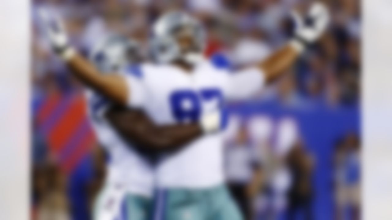 Dallas Cowboys defensive end Jason Hatcher (97) and DeMarcus Ware, rear, celebrate during the second half of an NFL football game against the New York Giants, Wednesday, Sept. 5, 2012, in East Rutherford, N.J. The Cowboys won 24-17. (AP Photo/Julio Cortez)