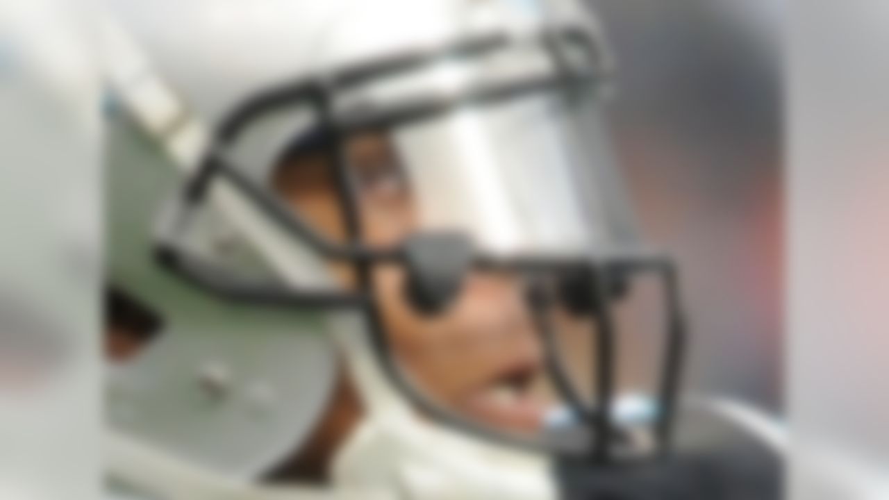 1) Who is this NFL player who took the league by storm in 2011, passing for more than 4,000 yards in his rookie season?