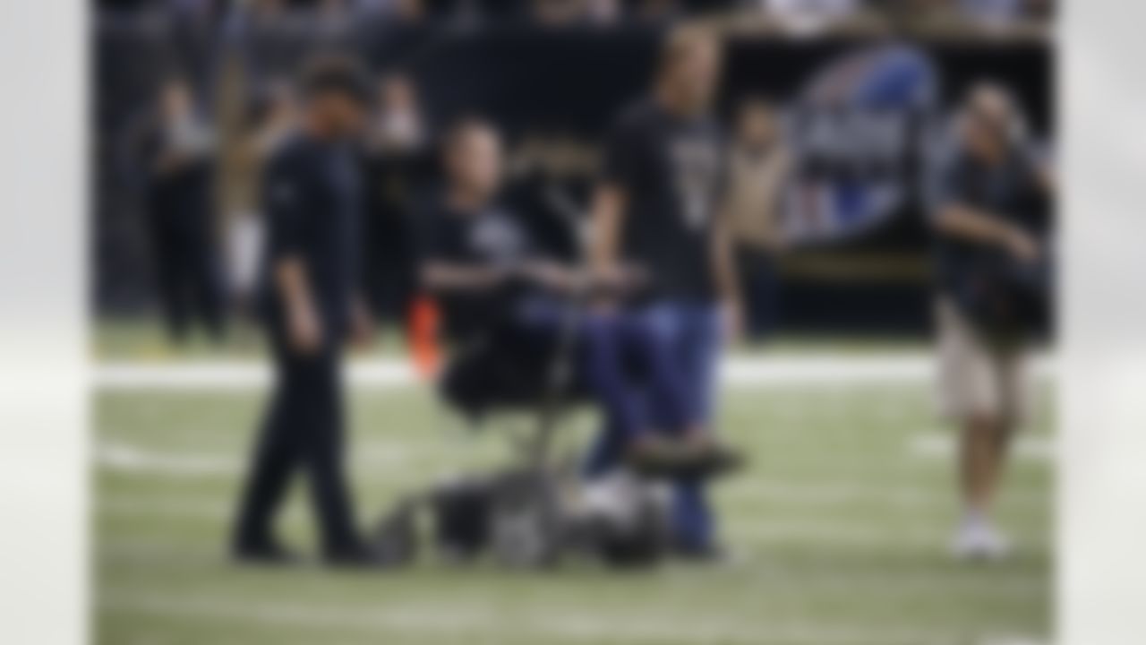 Coach Sean Payton goes out to the field with Former Saints player Steve Gleason prior to the game against the Falcons at the Superdome during an NFL game in New Orleans, Louisiana on Sunday September 8, 2013. (AP Photo/David Seelig)