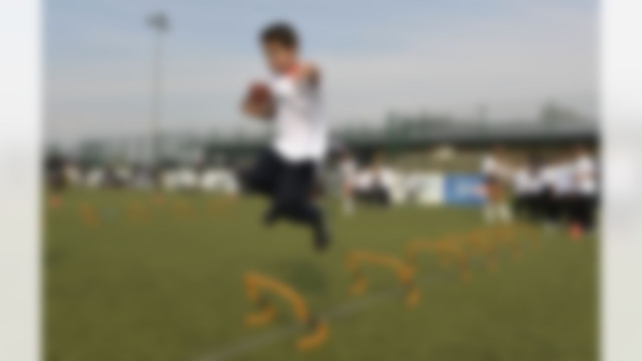 A boy participates in a drill during an Oakland Raiders football clinic in London. The Oakland Raiders and the Miami Dolphins play in the NFL International Series at Wembley Stadium in London on Sunday, Sept 28. (Sean Ryan/NFL)