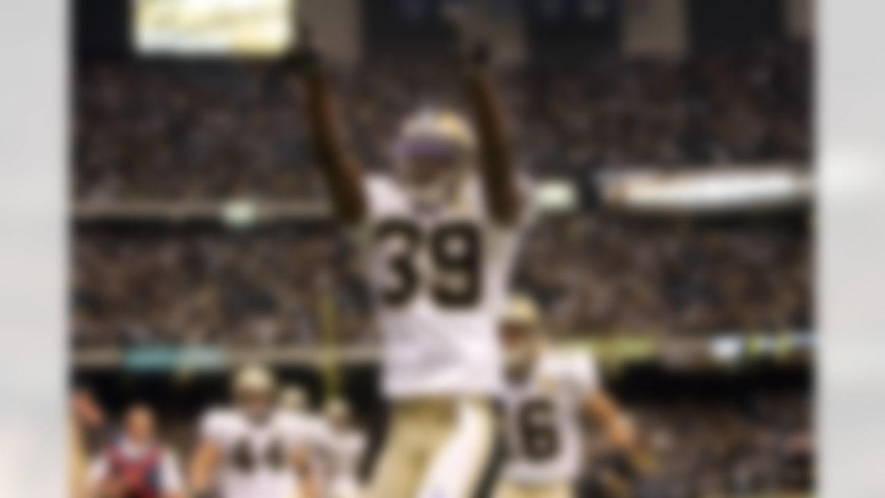 New Orleans' Curtis Deloatch (right) reacts after scoring a touchdown off a blocked punt during the first half against Atlanta Monday, September 25, 2006, at the Superdome in New Orleans, Louisiana. Photo by Getty Images.