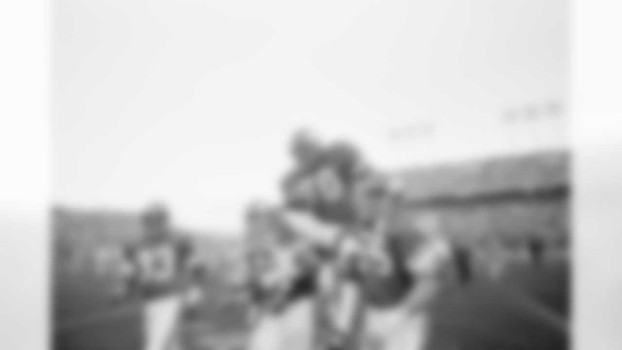 Minnesota Viking tackle Jim Marshall clutches the game ball as he is carried from the field by teammates Doug Southerland, left, and Scott Studwell after the Vikings had beaten Buffalo 10-3, in Bloomington, Minn., on Sunday, Dec. 9, 1979. (AP Photo/Jim Mone)