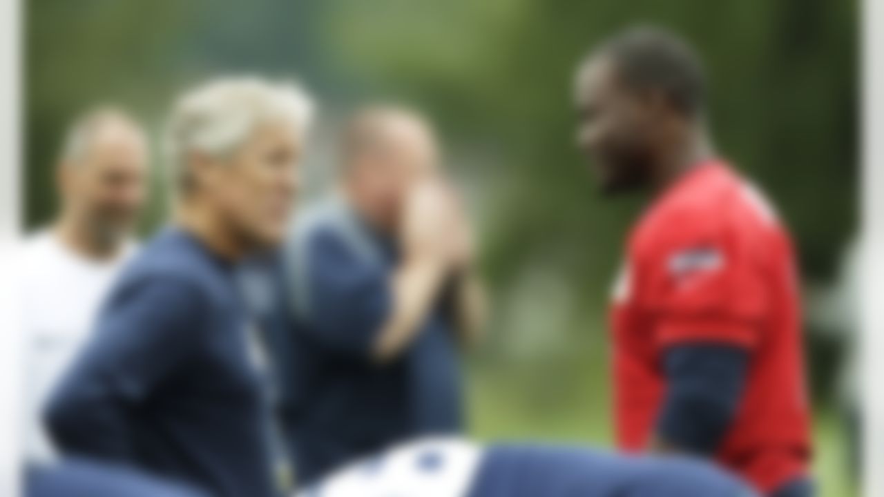 Seattle Seahawks coach Pete Carroll, left, chats with quarterback Tavaris Jackson, right, Saturday, July 28, 2012, on the first day of Seattle Seahawks NFL football training camp. (AP Photo/Ted S. Warren)