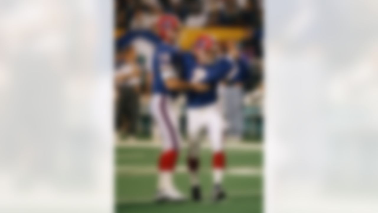 Buffalo Bills Frank Reich hugs Bills kicker Steve Christie after his 54-yard field goal, which broke the previous Super Bowl record of 48 yards, during Super Bowl XXVIII with the Dallas Cowboys, Sunday, Jan. 4, 1994 in Atlanta. (AP Photo/Amy Sancetta)