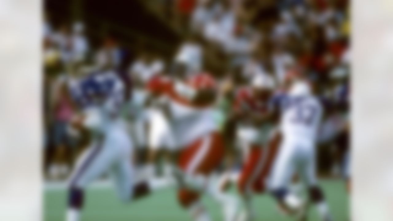 Philadelphia Eagles running back Ricky Watters (32) stiffarms Seattle Seahawks defensive tackle Cortez Kennedy (96) during the NFL Pro Bowl, a 26-23 overtime AFC victory on February 2, 1997, at Aloha Stadium in Honolulu, Hawaii. (National Football League)