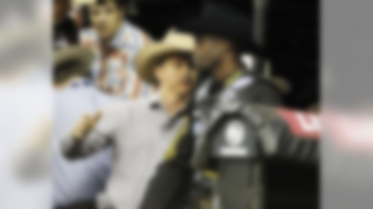 Former bull riding champion Ty Murray talks with Cincinnati Bengal receiver Chad Ochocinco before Ochocinco attempted to ride a bull named Deja Blu during the Professional Bull Riders' Lucas Oil Invitation bull riding event in Duluth, Ga., Saturday, May 14, 2011. (AP Photo/John Bazemore)