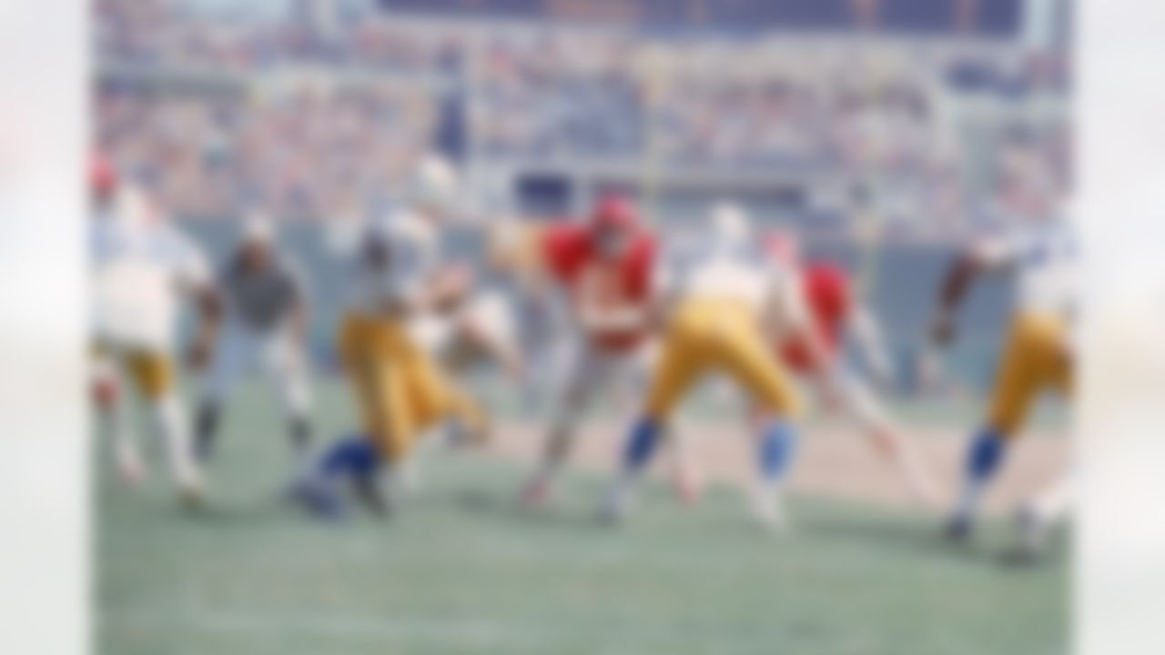 Quarterback John Hadl #21of the San Diego Chargers drops back to pass as defensive tackle Curley Culp #61 of the Kansas City Chiefs tries to apply pressure at San Diego Stadium on September 19, 1971 in San Diego, California. The Chargers defeated the Chiefs 21-14. (National Football League)