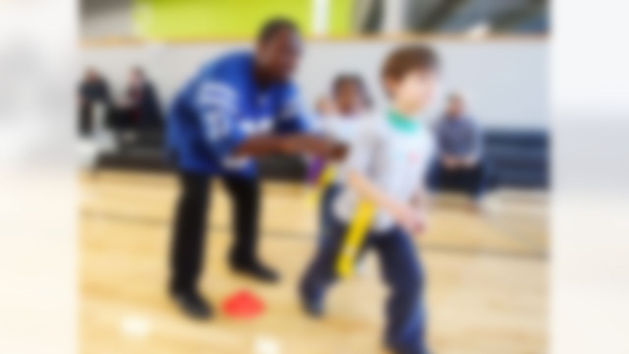 Feb. 02, 2012; Indianapolis, IN, USA; Indianapolis Colts cornerback Brandon King (37) gives instructions to a youngster in the NFL Play 60 event at YET Facility. Mandatory credit: Michael Hickey-US PRESSWIRE