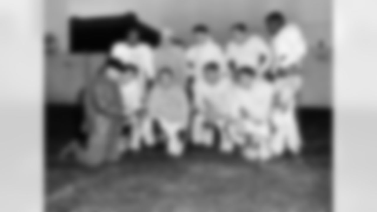 Coach Paul Brown, wearing baseball cap at lower left, poses with Cleveland Browns players on Dec. 23, 1952, who will be ending their seventh season Sunday in an NFL championship game against the Detroit Lions. At front, left to right: Coach Brown, Dante Lavelli, Lin Houston, Frank Gatski, and George Young. Standing, left to right: Marion Motley, Otto Graham, Mac Speedie, Lou Groza, and Bill Willis. (AP Photo/Julian Wilson)