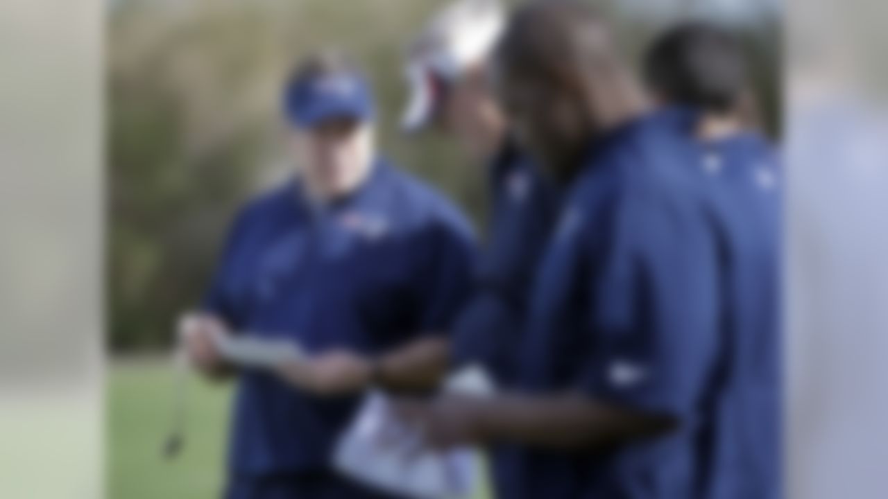 New England Patriots head coach Bill Belichick, left, talks with assistants during practice Wednesday, Jan. 28, 2015, in Tempe, Ariz. The Patriots play the Seattle Seahawks in NFL football Super Bowl XLIX Sunday, Feb. 1, in Glendale, Ariz. (AP Photo/Mark Humphrey)