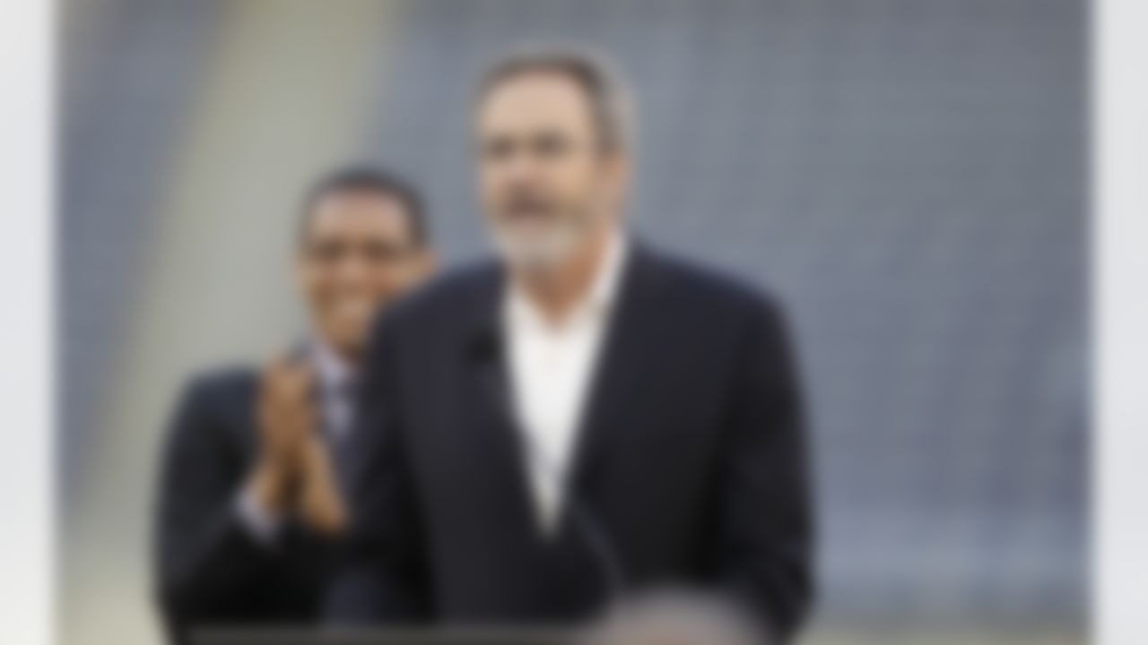 Former quarterback Dan Fouts speaks in front of pastor Miles McPherson during a public memorial service for football player Junior Seau at Qualcomm Stadium Friday, May 11, 2012, in San Diego. Seau committed suicide on May 2 at his Oceanside, Calif., home. He played parts of 20 seasons in the NFL, with the San Diego Chargers, Miami Dolphins and New England Patriots. (AP Photo/ Gregory Bull)