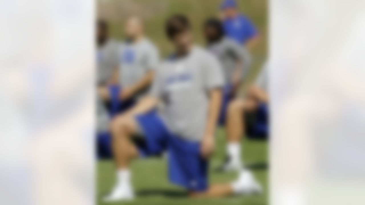 New York Giants quarterback Eli Manning stretches before a physical evaluation drill on opening day of NFL football training camp in Albany, N.Y., Thursday, July 26, 2012. (AP Photo/Kathy Willens)