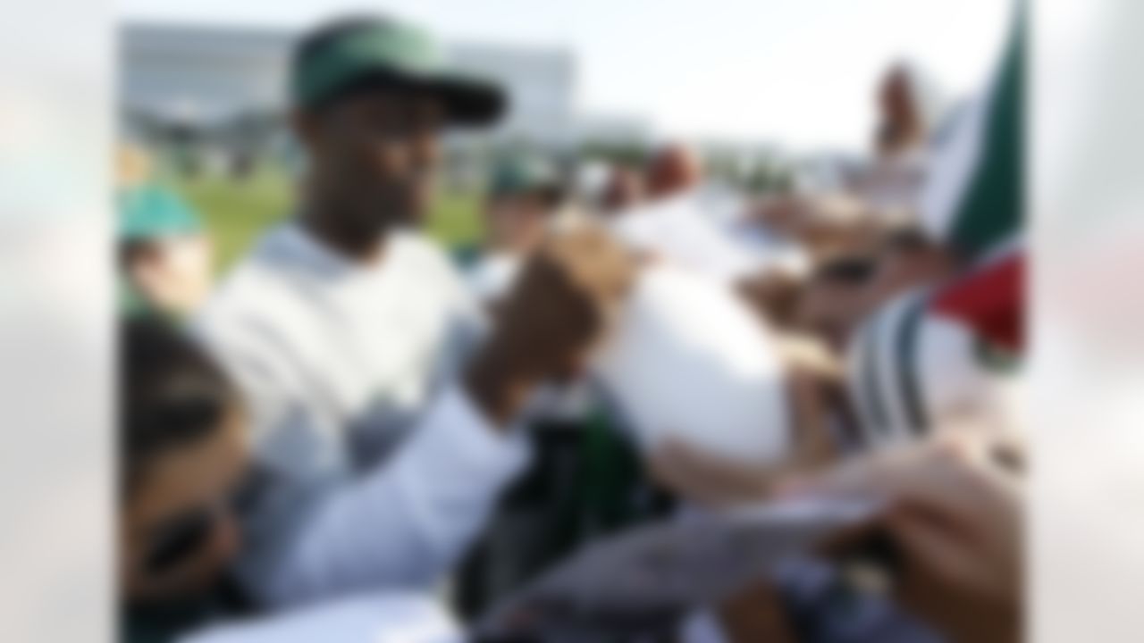 New York Jets wide receiver Plaxico Burress signs autographs for fans at the end of practice during NFL football training camp, Tuesday, Aug. 2, 2011, at Atlantic Health Training Center in Florham Park, N.J. (AP Photo/Julio Cortez)