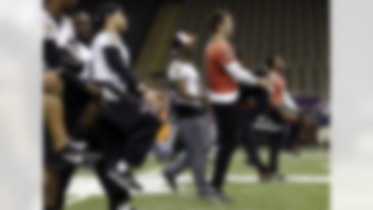 Baltimore Ravens quarterback Joe Flacco, at right in red, warms up during an NFL Super Bowl XLVII walkthrough on Saturday, Feb. 2, 2013, in the Mercedes-Benz Superdome in New Orleans. The Ravens face the San Francisco 49ers in Super Bowl XLVII on Sunday. (AP Photo/Patrick Semansky)