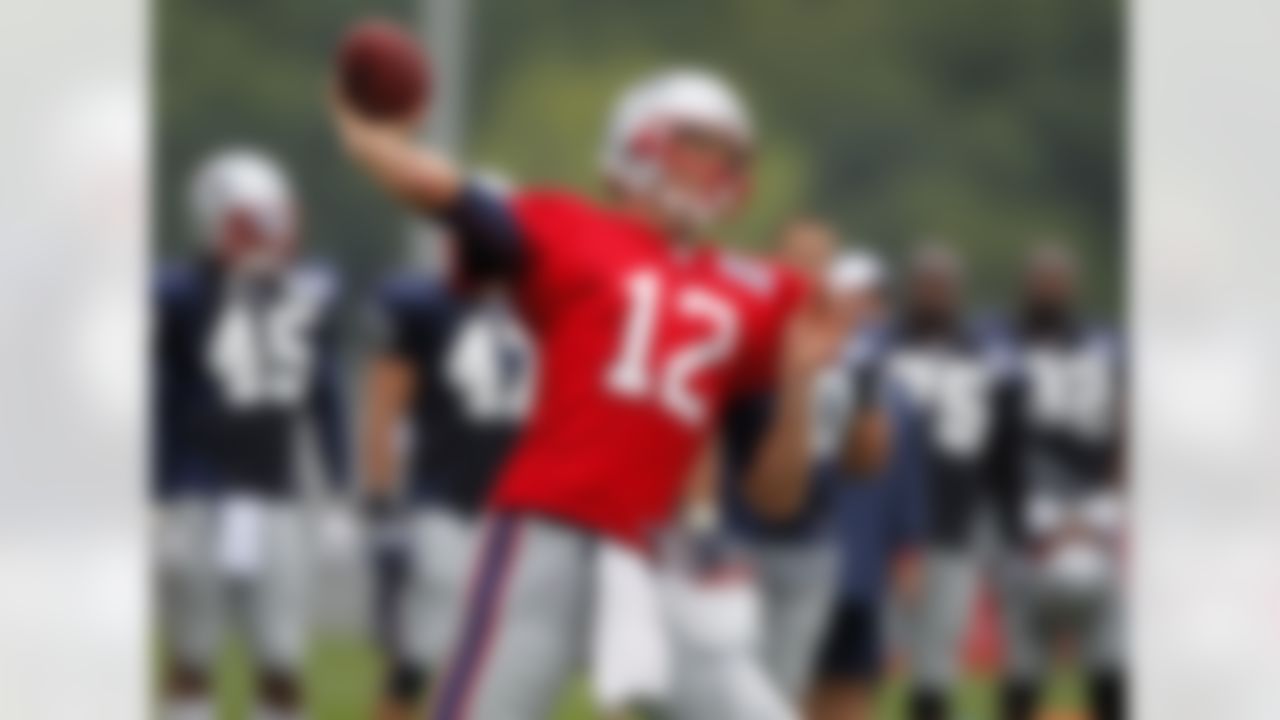 New England Patriots quarterback Tom Brady (12) delivers a pass during NFL football training camp in Foxborough, Mass., Sunday, July 29, 2012. (AP Photo/Steven Senne)