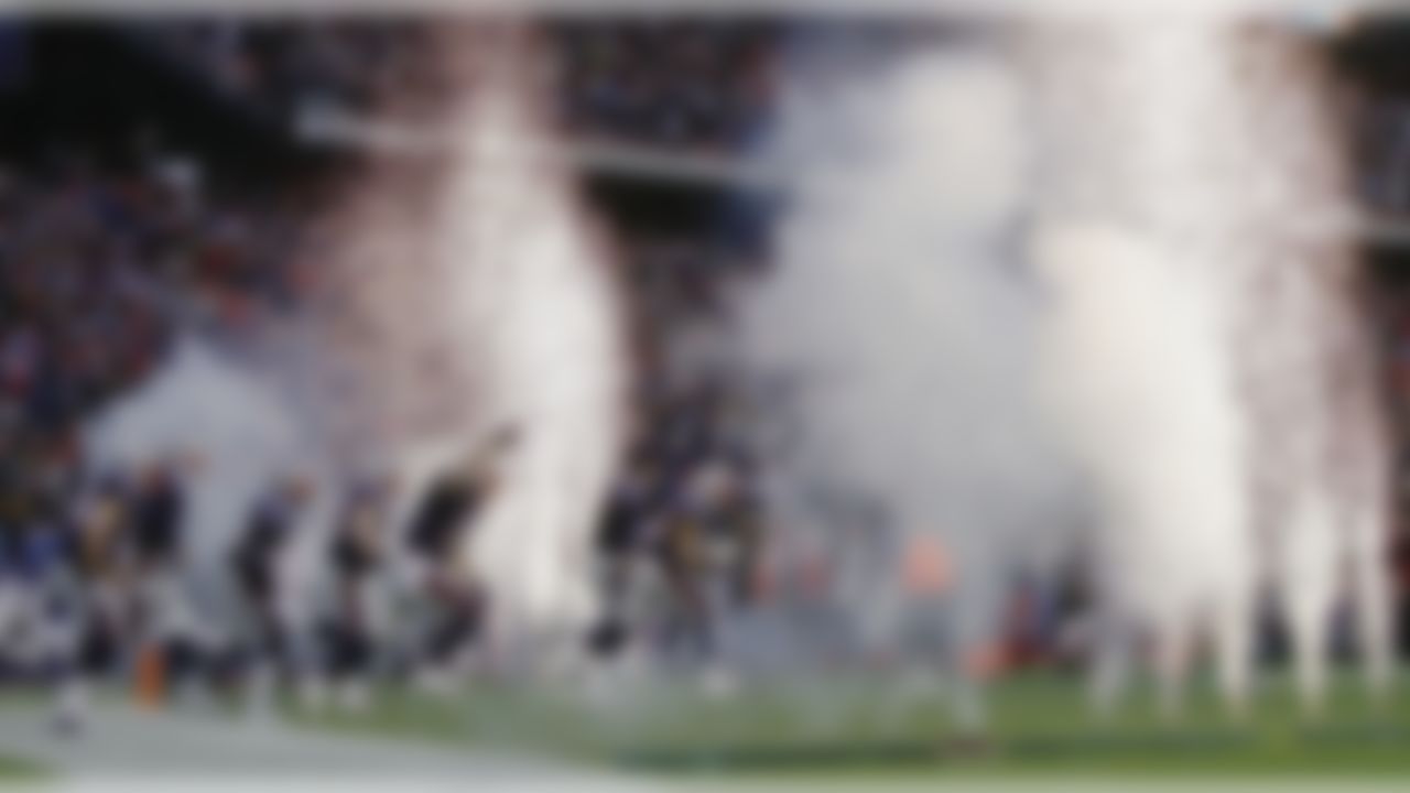 The Patriots run onto the field to start the AFC Championship Game against the Ravens.