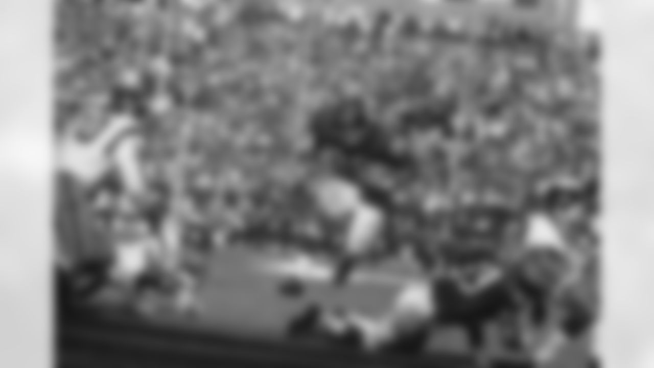 Fullback Chuck Mercein of the New York Giants, 29, carries ball through what seems to be a wide opening in third quarter at New York's Yankee Stadium on Oct. 16, 1966. This play ended in no gain as Gregg Larson, 53, and Washington Redskins back Sam Huff, 70, move in to make the tackle. (Associated Press)