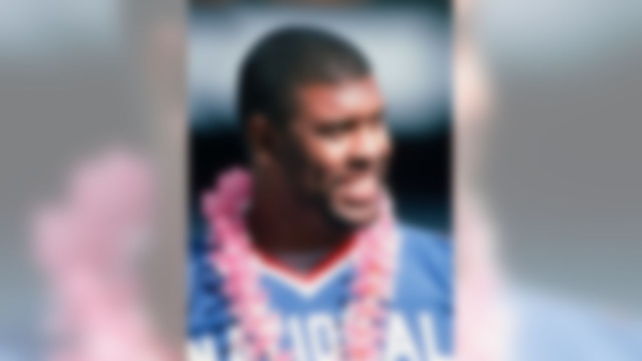 NFC player Reggie White (92) smiles form the sidelines during the Pro Bowl between the AFC and the NFC on February 6, 1994 in Honolulu, Hawaii. The NFC won the game 17-3. (AP Photo/Paul Spinelli)