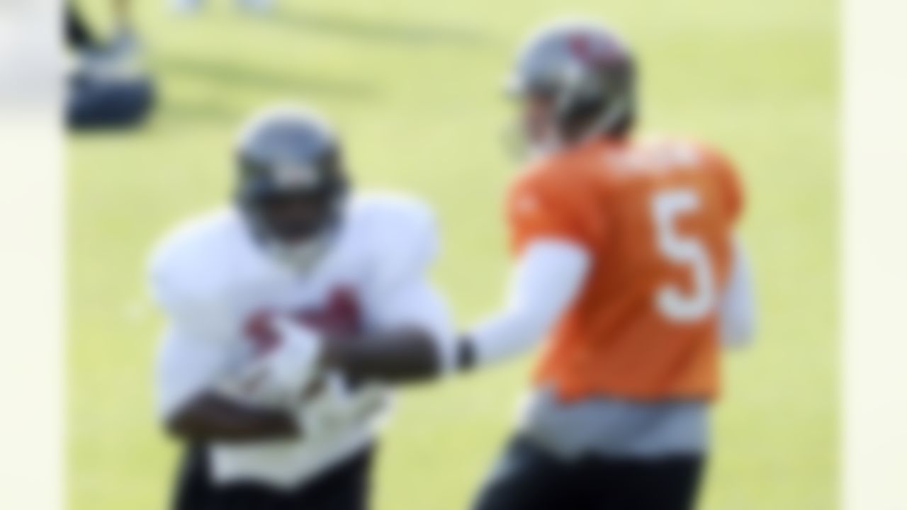 Tampa Bay Buccaneers' Josh Freeman, right, hands the ball to Earnest Graham, during a team training session, Bagshot, west of London, Thursday Oct. 20, 2011. The Buccaneers will face Chicago Bears at London's Wembley stadium on Sunday. (AP Photo/Tom Hevezi)