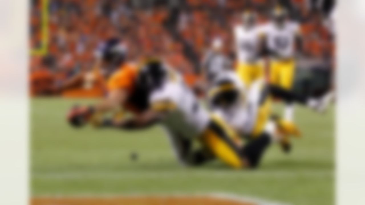 Denver Broncos wide receiver Eric Decker #87 dives for the end zone while being tackled by Pittsburgh Steelers free safety Ryan Mundy #29 during the NFL regular season game between the Pittsburg Steelers and the Denver Broncos at Sports Authority Field at Mile High in Denver, CO on September 9, 2012. (Ric Tapia/NFL)