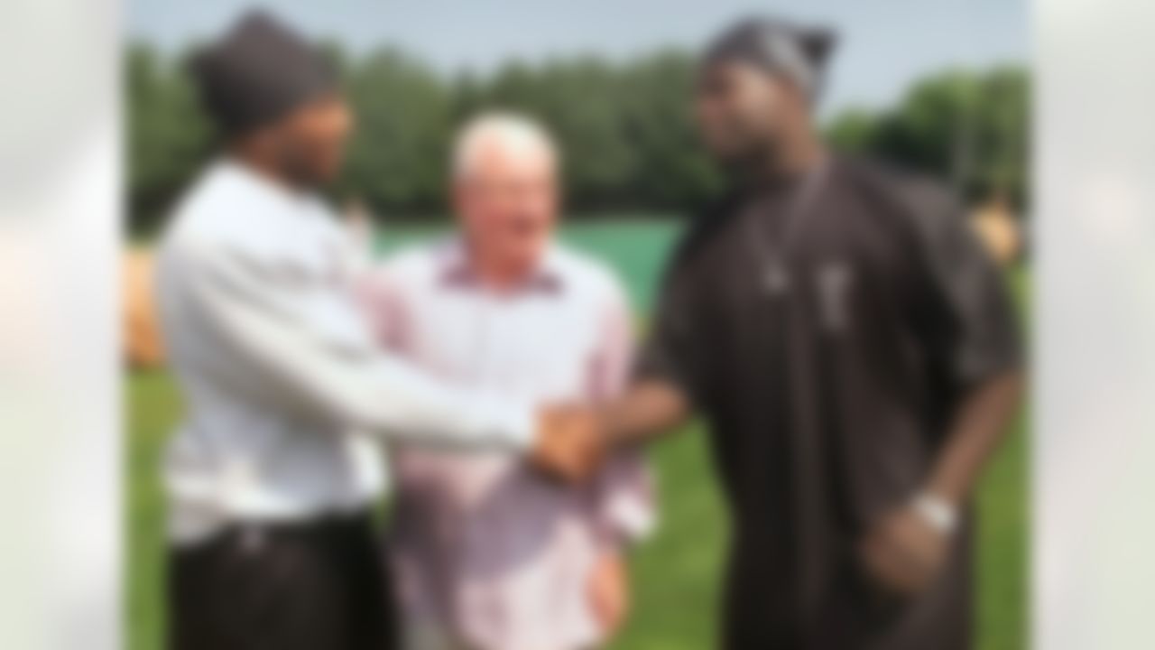 Baltimore Ravens team owner Art Modell, center, introduces heavyweight champion Hasim Rahman, right, to Ravens linebacker Ray Lewis before the start of practice at the team's minicamp at their training facility in Owings Mills, Md., Wednesday, June 13, 2001. Rahman was invited to the camp to deliver a motivational address to the Super Bowl Champions. (AP Photo/Roberto Borea)