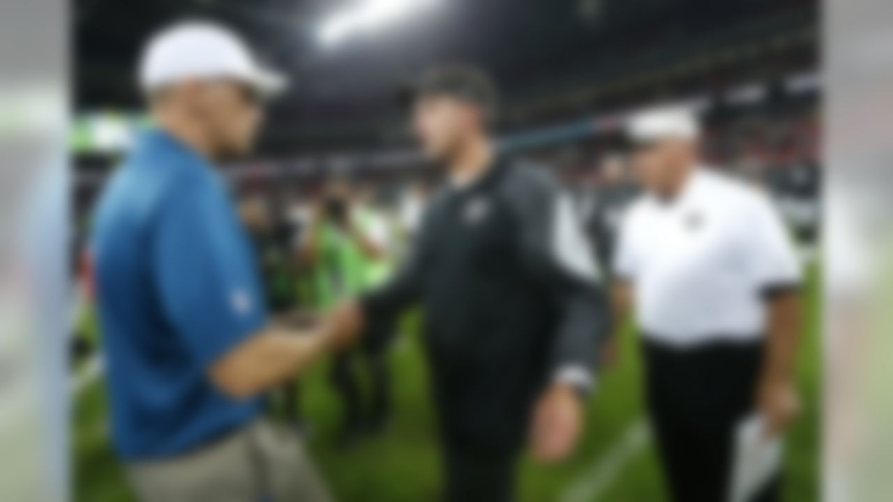 Oakland Raiders head coach Dennis Allen (right) and Miami Dolphins head coach Joe Philbin shake hands after the game at Wembley Stadium on Sunday September 28, 2014 in London, England. Miami won 38-14. (Ben Liebenberg/NFL)