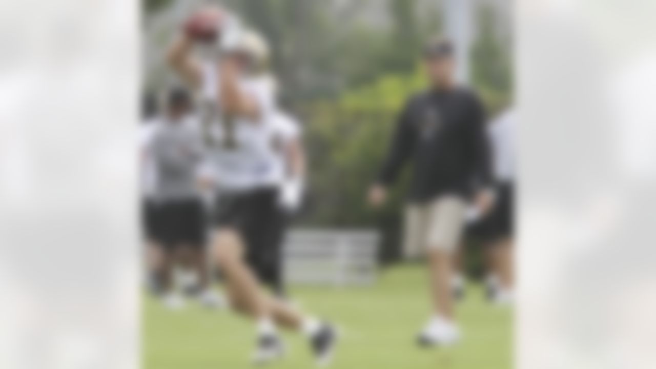 New Orleans Saints coach Sean Payton watches as wide receiver Matt Simon (81) catches a pass during the stretching exercises at the start of practice at the club's NFL football training facility in Metairie, La., Friday, June 4, 2010. (AP Photo/Bill Haber)