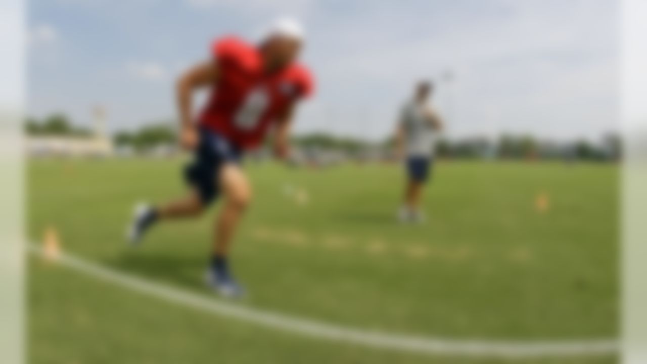 Tennessee Titans quarterback Matt Hasselbeck (8) runs a drill as assistant strength coach Jason Novak looks on during NFL football camp at Titans' headquarters Monday, July 30, 2012 Nashville, Tenn. (AP Photo/Wade Payne)