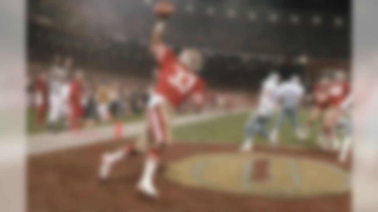 Roger Craig #33 runs with the ball push in the air after scoring a touchdown early in the first quarter against the Dallas cowboys in Candlestick Park, San Francisco on Monday, Dec. 20, 1983. Craig second two touchdowns in the 49ers 42-17 win that gave them the NFC west title. (AP Photo/Eric Risberg)