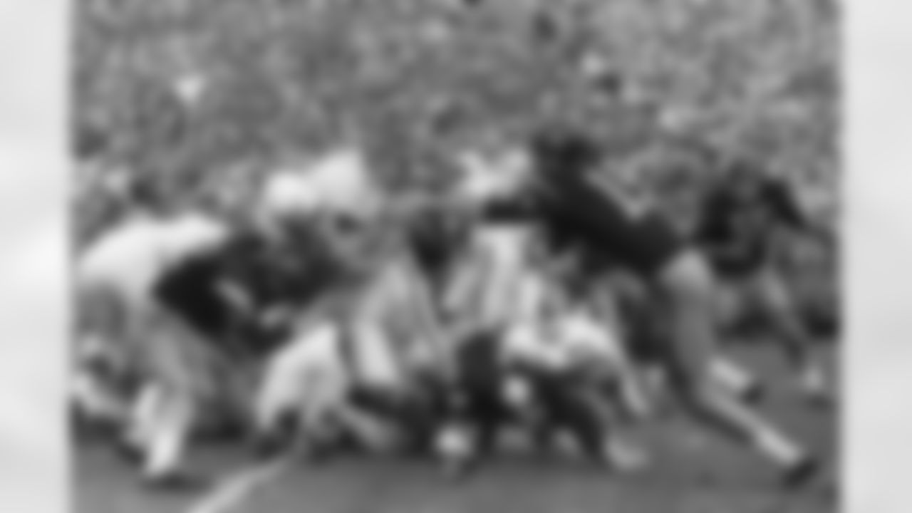 Wisconsin fullback Ralph Kurek (34), smashes off tackle into the end zone to score his teams first touchdown against Southern California while going down to a 42-37 defeat at the Rose Bowl, Jan. 2, 1963, at Pasadena CA. Kurek takes hand-off from quarterback Ron VanderKelen, and then hit at goal line by USC quarterback Pete Beathard (12) as end Hal Bedsole (19) lunges for his bottom, he shoves Beathard back and scores. (Associated Press)