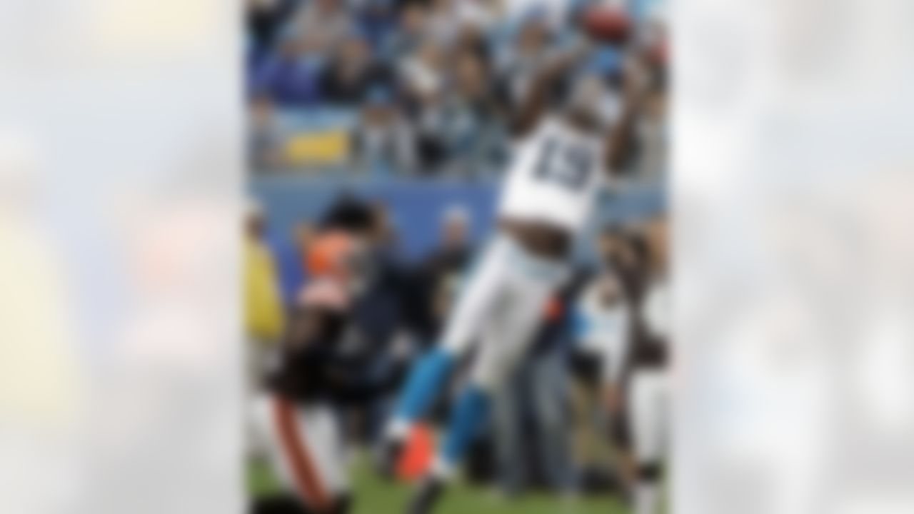 Carolina Panthers' Keyshawn Johnson (19) jumps high to make a catch as Cleveland Browns' Brodney Pool (21) defends during the second quarter of an NFL football game in Charlotte, N.C., Sunday, Oct. 8, 2006.
