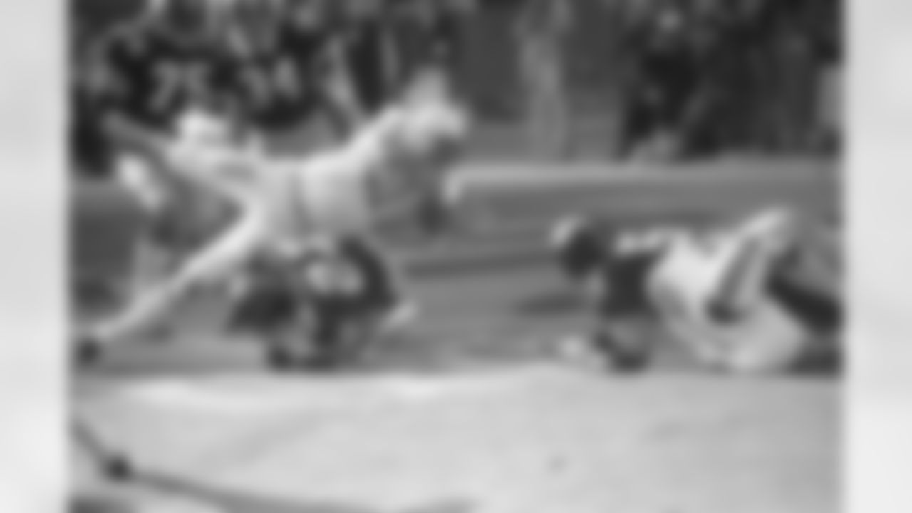 Miami Dolphins Jim Kiick goes headfirst over Pittsburgh Steelers" Glen Edwards Dec. 31, 1972 as Kiick scores in third quarter of the AFC championship game at Pittsburgh's Three Rivers Stadium. (Associated Press)
