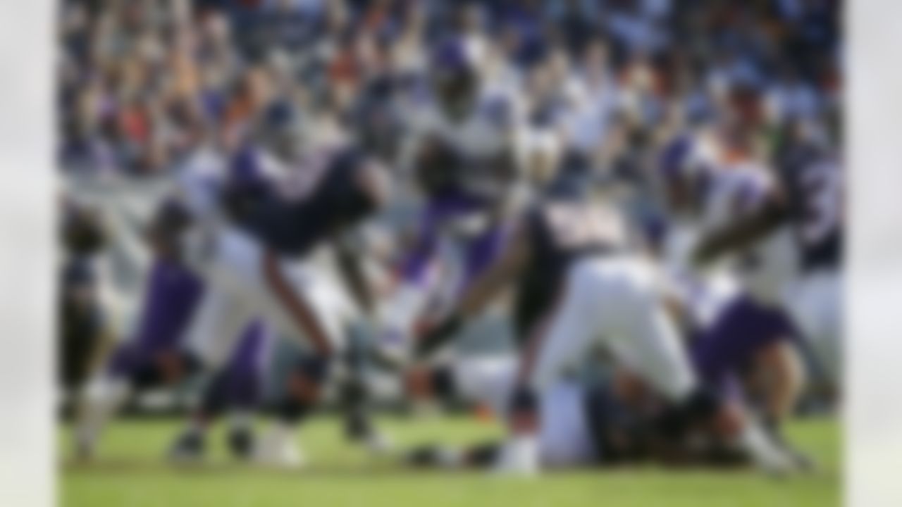 Minnesota Vikings running back Adrian Peterson (28) leaps over players as he carries the ball against Chicago Bears defenders during the first half of an NFL football game, Sunday, Nov. 1, 2015, in Chicago. (AP Photo/Nam Y. Huh)