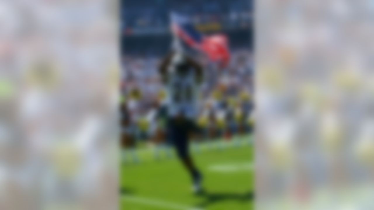 SAN DIEGO - SEPTEMBER 9: Running back LaDainian Tomlinson of the San Diego Chargers enters the game with the American flag against the Chicago Bears at Qualcomm Stadium September 9, 2007 in San Diego, California. (Photo by Donald Miralle/Getty Images)
