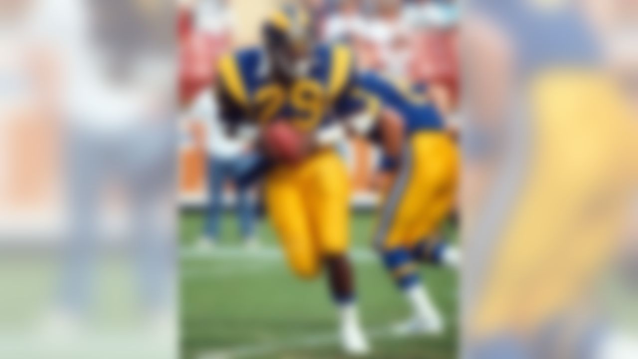 Hall of Fame running back Eric Dickerson (29) of the Los Angeles Rams takes the handoff from quarterback Steve Dils (8) before he throws a touchdown on a halfback option play during a 14-7 victory over the Atlanta Falcons on October 26, 1986, at Anaheim S (National Football League)
