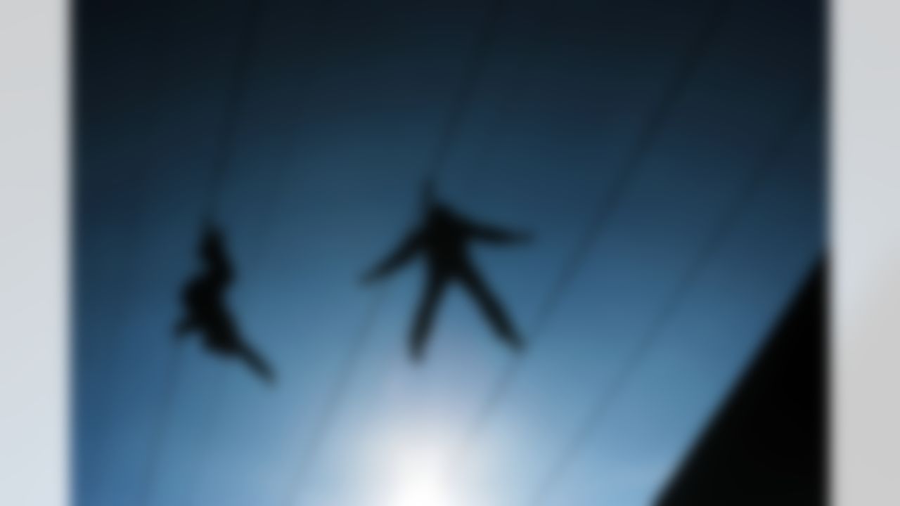 Zip-line riders sail over Capitol Street in the Super Bowl Village on Thursday, Feb. 2, 2012, in Indianapolis. The New England Patriots are scheduled to face the New York Giants in NFL football's Super Bowl XLVI on Feb. 5. (AP Photo/Jeffrey Furticella)