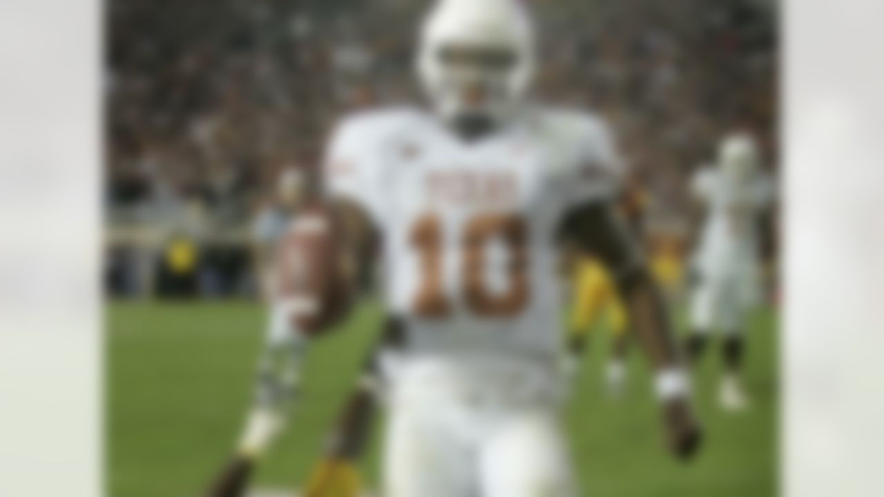 The result: Texas beats USC, 41-38, for the 2005 national title
The skinny: The greatest college football game ever? A strong case can be made that it was. Texas QB Vince Young played one of the greatest individual games in college history, given the stakes. Second-ranked Texas upset the top-ranked Trojans, 41-38, and the game featured 32 fourth-quarter points and 53 second-half points. Young accounted for 467 yards of offense and three TDs. His last score came on an 8-yard, fourth-down run with 19 seconds left. USC's LenDale White -- who rushed for 124 yards and three TDs -- had failed on a fourth-and-2 run from Texas' 44 with 2:09 left to set up the Longhorns' final drive. USC was going for a share of its third consecutive title and fell despite rolling up 574 yards of offense.
