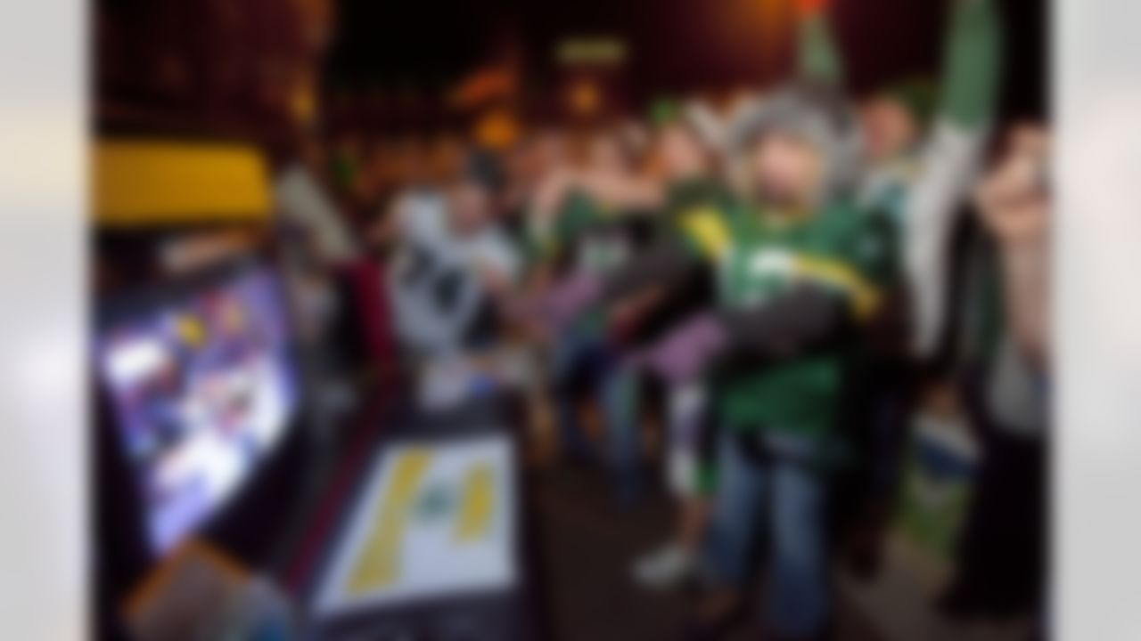 Packers fans watch the Super Bowl Trophy presentation, Sunday, Feb. 6, 2011, in the parking lot of Lambeau Field in Green Bay, Wis., after the Green Back Packers won 31-25 over the Pittsburgh Steelers in the NFL's Super Bowl XLV championship football game. (AP Photo/Mike Roemer)