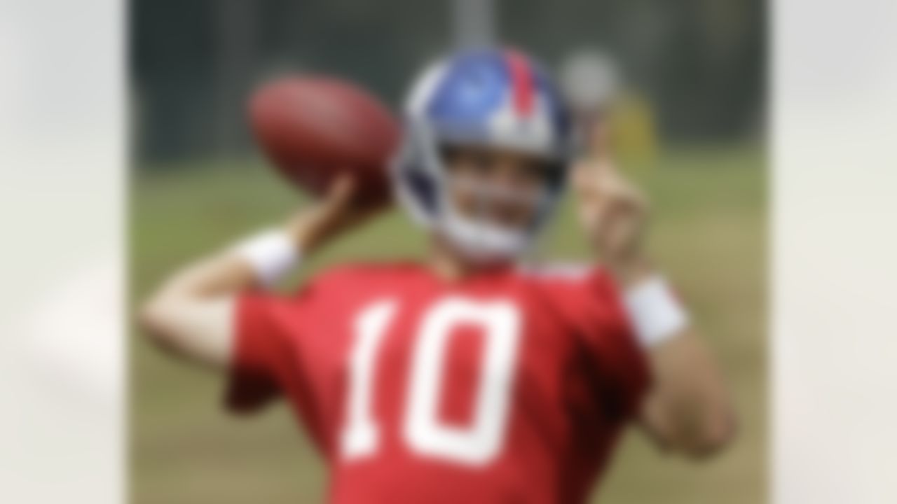New York Giants quarterback Eli Manning drops back for a pass at the New York Giants NFL football training camp in Albany, N.Y., Friday, July 27, 2012. (AP Photo/Kathy Willens)