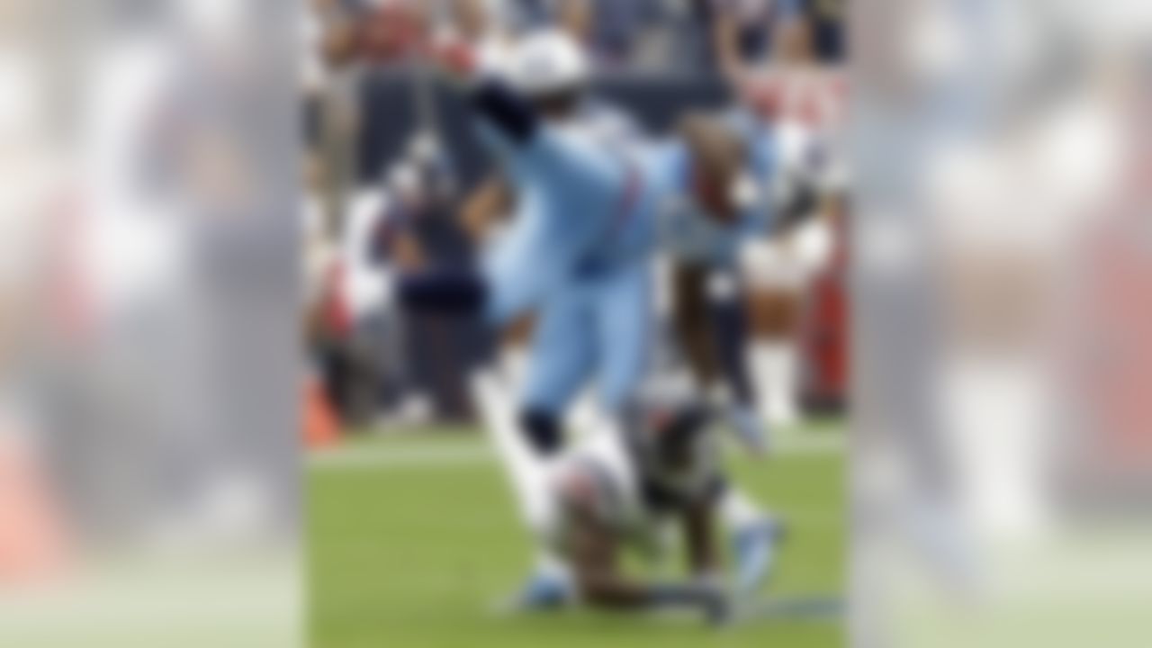 Tennessee Titans' Chris Johnson (28) is upended by Houston Texans' Kareem Jackson (25) during the first quarter of an NFL football game Sunday, Sept. 15, 2013, in Houston. (AP Photo/Patric Schneider)
