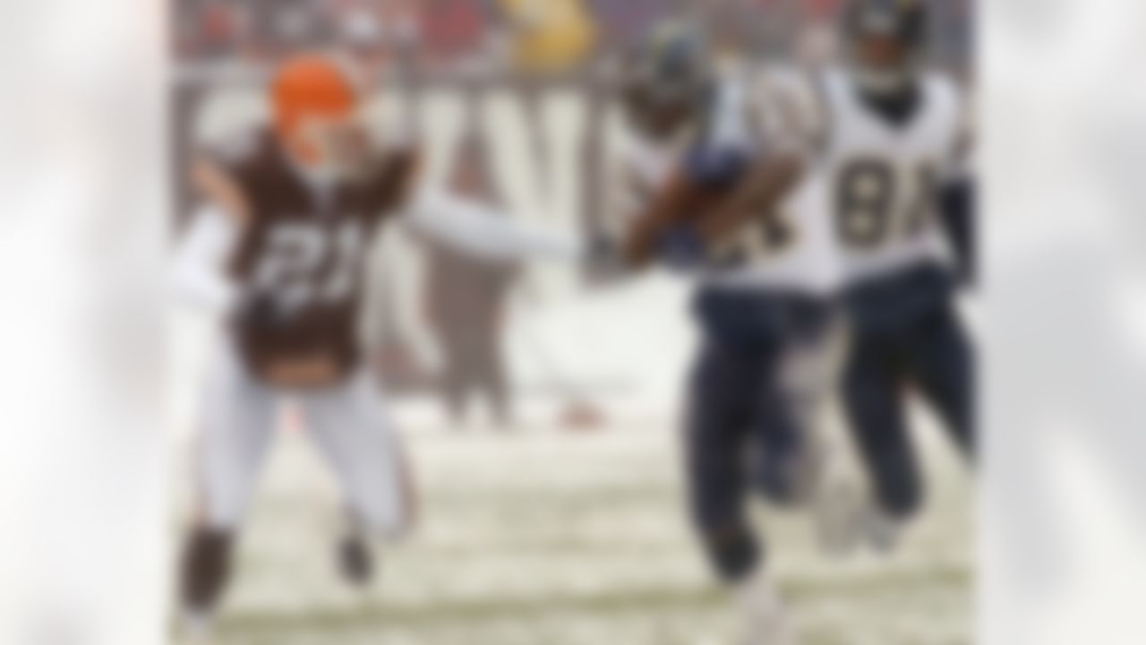 San Diego Chargers' LaDainian Tomlinson runs for 20 yards against Cleveland Browns defender Lewis Sanders, left, in the first quarter Sunday, Dec. 19, 2004, in Cleveland. Trailing the play is Chargers' Kassim Osgood (81). Tomlinson rushed for 111 yards and two touchdowns as the Chargers won 21-0.(AP Photo/Mark Duncan)