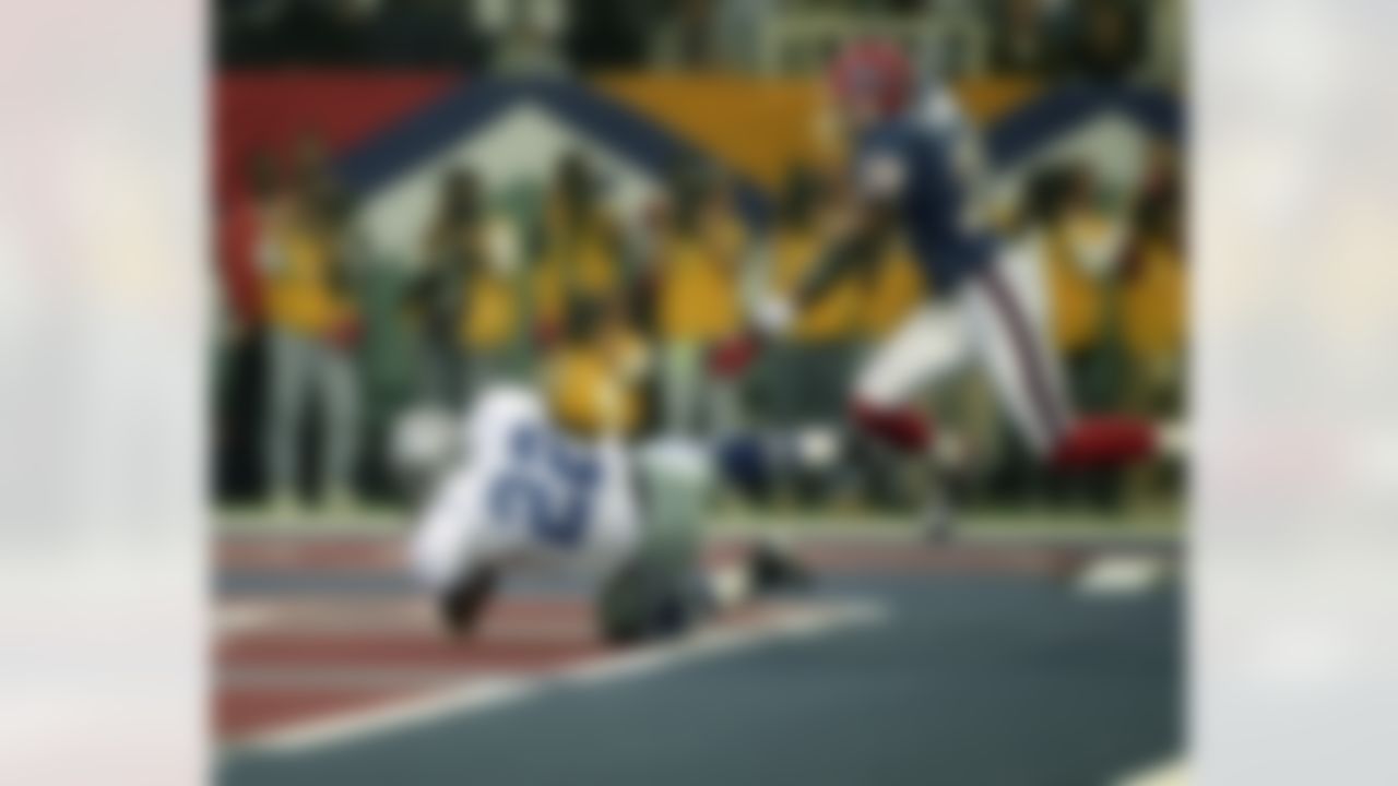Dallas Cowboys running back Emmitt Smith (22) tumbles into the end zone for a 15-yard touchdown carry ahead of Buffalo Bills cornerback Thomas Smith (28) during Super Bowl XXVIII, a 30-13 Cowboys victory on January 30, 1994, at the Georgia Dome in Atlanta. (National Football League)