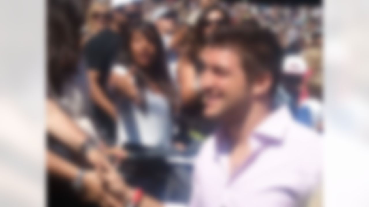 New York Jets quarterback Tim Tebow greets fans as he makes his way to the stage before delivering a sermon at Qualcomm Stadium in San Diego, California on June 17, 2012. (Kenny Legan/NFL)