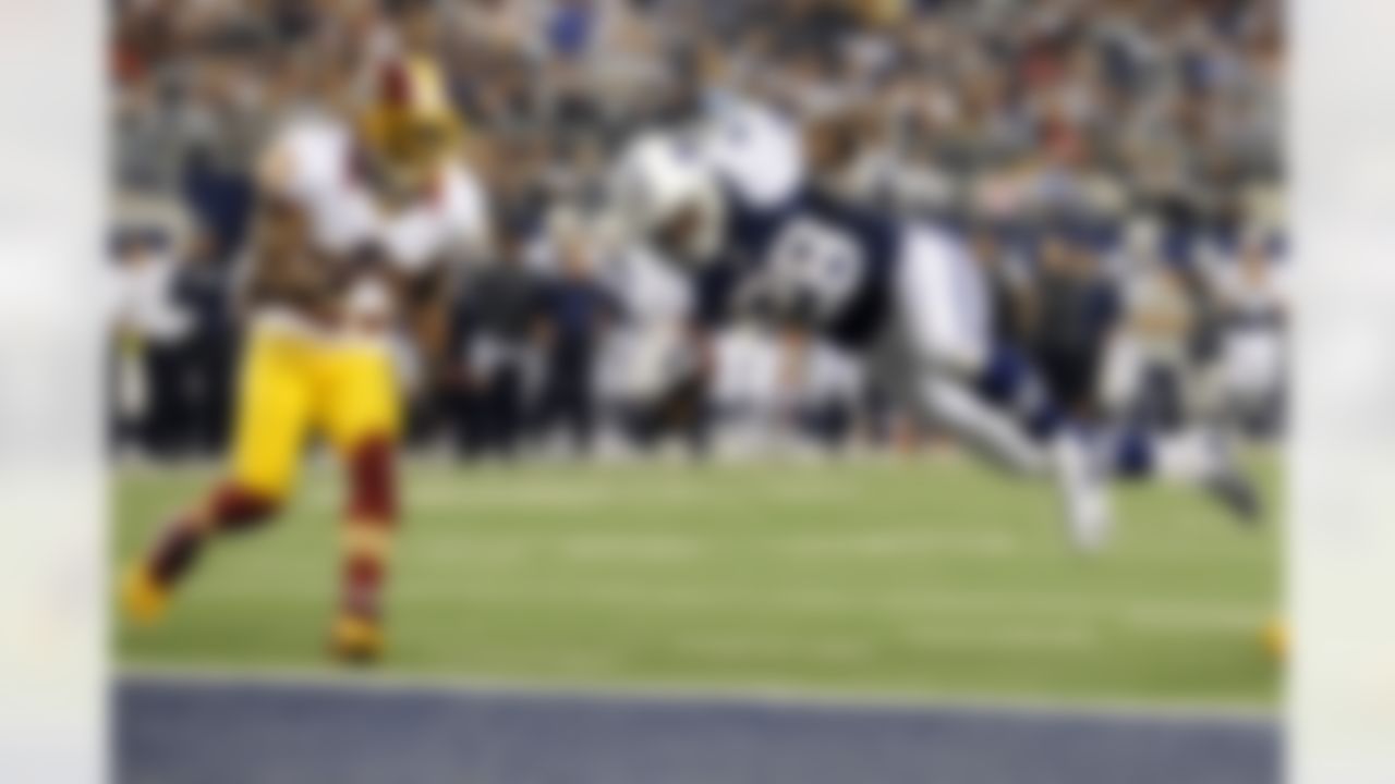 Dallas Cowboys' Felix Jones (28) dives into the end zone for a touchdown as Washington Redskins cornerback DeAngelo Hall (23) watches in the second half of an NFL football game, Thursday, Nov. 22, 2012, in Arlington, Texas. (AP Photo/Matt Strasen)