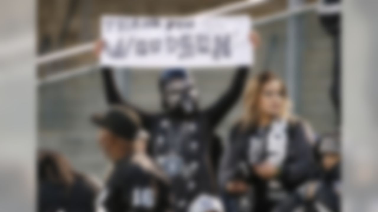 A fan holds up a sign for Oakland Raiders cornerback Charles Woodson before an NFL football game between the Oakland Raiders and the San Diego Chargers in Oakland, Calif., Thursday, Dec. 24, 2015. (AP Photo/Tony Avelar)