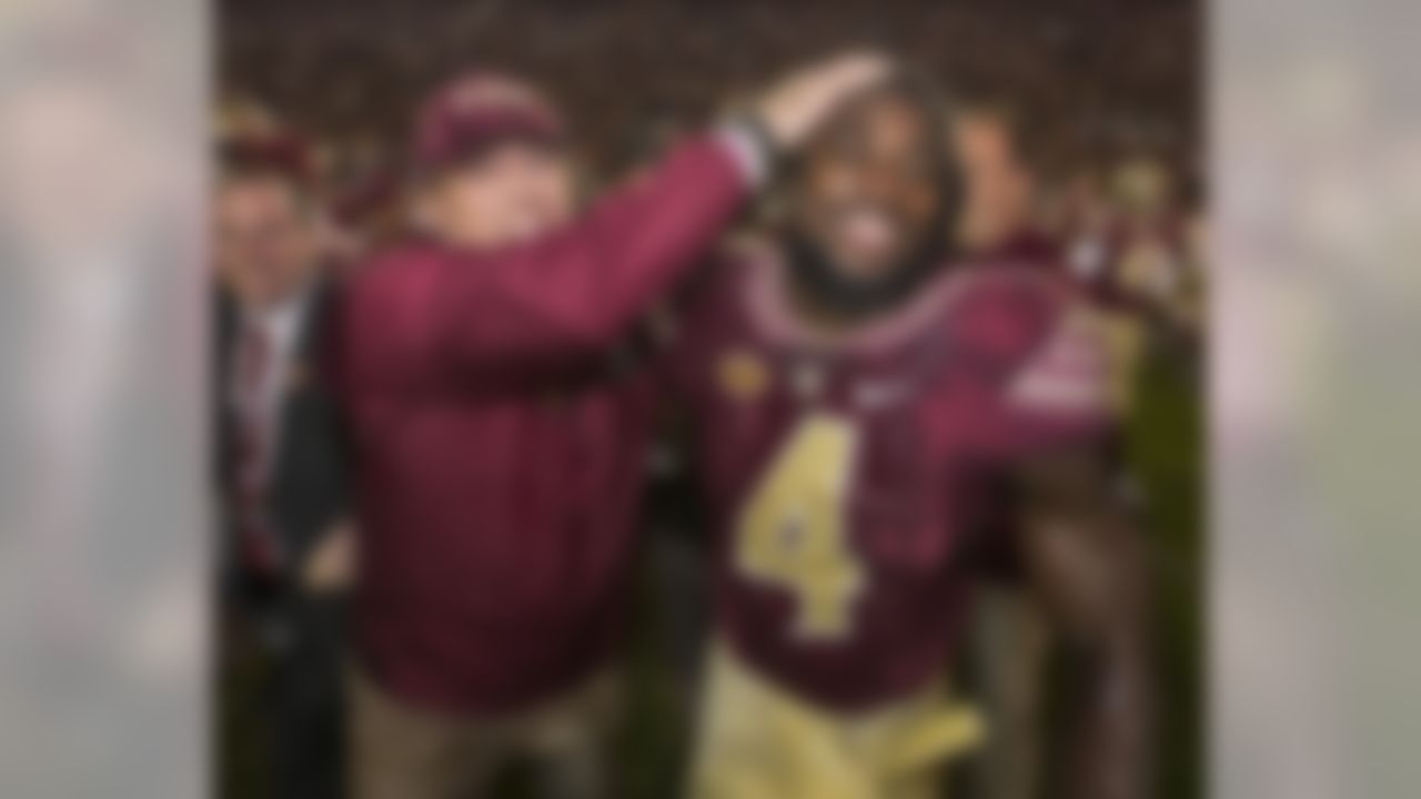 Florida State coach Jimbo Fisher and running back Dalvin Cook celebrate the team's 31-13 win over Florida in an NCAA college football game in Tallahassee, Fla., Saturday, Nov. 26, 2016. (AP Photo/Mark Wallheiser)