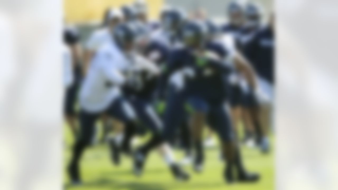Seattle Seahawks running back Marshawn Lynch, right, carries the ball, Friday, Aug. 3, 2012, during NFL football training camp drills, in Renton, Wash. (AP Photo/Ted S. Warren)